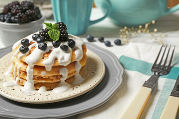 Stack of fresh pancakes with blueberry on plate