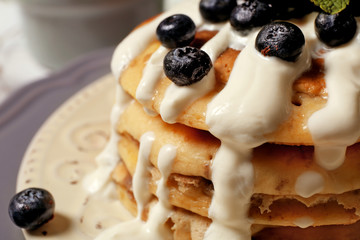 Stack of fresh pancakes with blueberry on plate