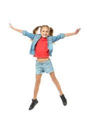 Emotional little girl jumping on white background