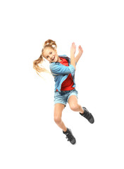 Emotional little girl jumping on white background