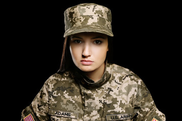 Pretty female soldier on black background