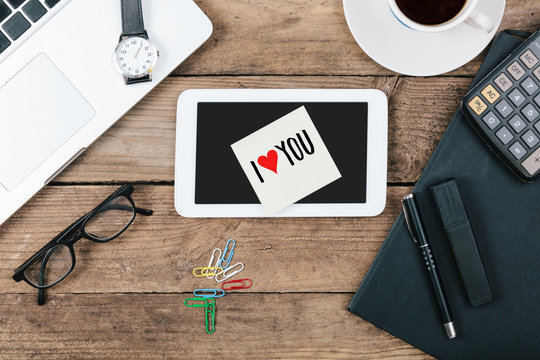 I Love You text on tablet computer, Office desk with computer te