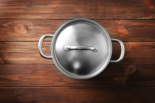 Stainless saucepan on wooden table
