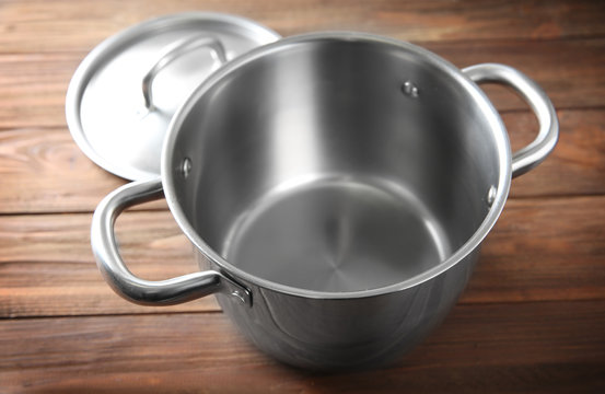 Stainless saucepan on wooden table