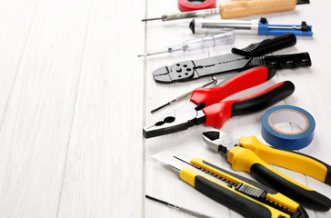 Different electrical tools on wooden table
