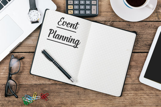 Event Planning text on note pad, Office desk with computer techn