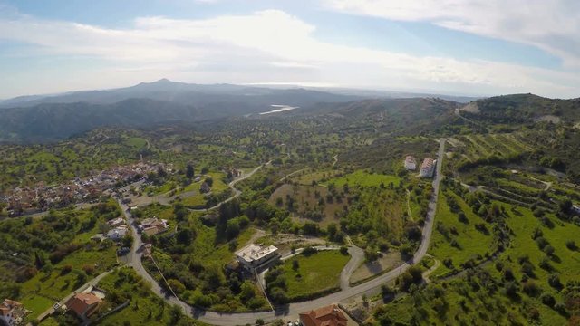 Nice mountain village, green landscape and olive gardens in Cyprus, aerial view