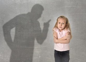 father or teacher shadow screaming angry reproving young sweet little schoolgirl or daughter