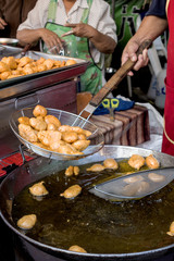 Deep-fried fish cakes made in big pot of oil in street food sho