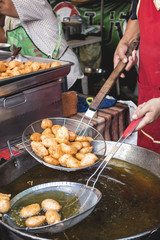  Deep-fried fish cakes made in big pot of oil in street food sho