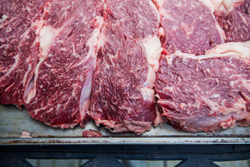 Raw Wagyu Kobe beef being prepared for barbecue cooking grilling