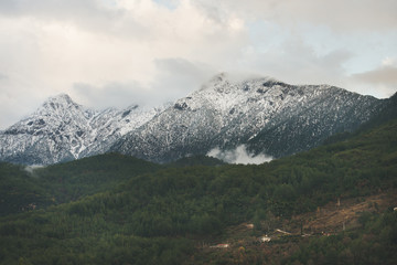 Green slopes of the Taurus mountains covered with snow in winter. Southern Turkey, Alanya, Dim Cay river valley