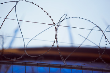 Fence with barbed wire. focus with shallow depth of field.