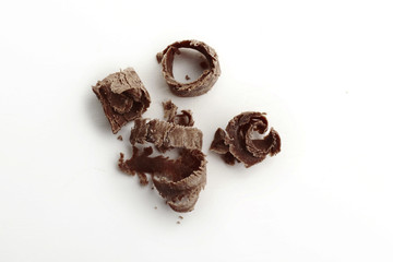 Milk chocolate shavings on white background