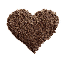 Heart made of milk chocolate shavings on white background