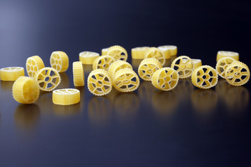 uncooked dry pasta in the shape of a wheel.