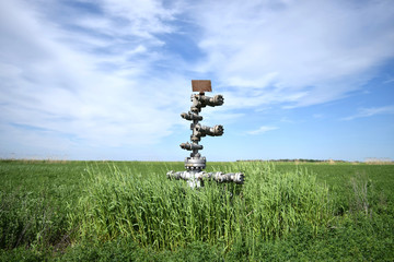 Canned oil well against the sky and field