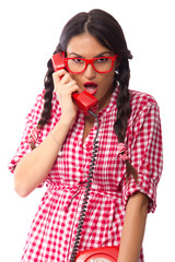 Retro style pinup girl receiving some shocking news over the phone