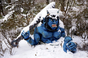 Naklejka premium Blue giant myth sculpture at Noboribetsu onsen snow winter