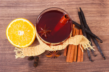 Glass of mulled wine wrapped scarf with fresh fragrant spices