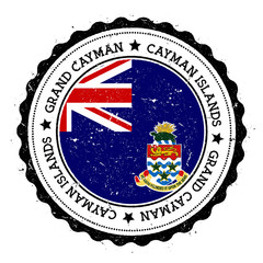 Grand Cayman flag badge. Vintage travel stamp with circular text, stars and island flag inside it. Vector illustration.