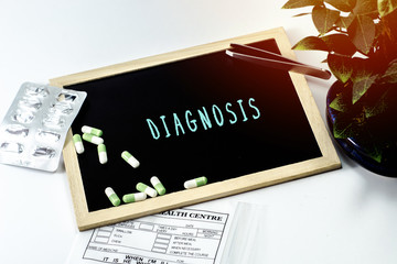 Medicine over the board written DIAGNOSIS on white isolated background