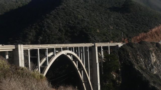 Zoom out view of cars driving on Bixby Creek Bridge, in Big sur, California, United states of america