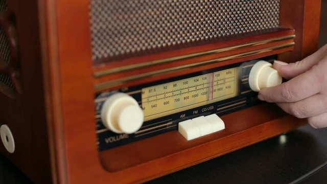 Hand tuning fm radio button. Vintage stereo and control button.