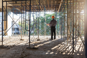 Construction concepts, Engineer and Architect working at Construction Site with blueprint