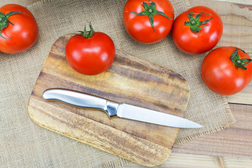 Closeup Fresh ripe tomatoes on wood background