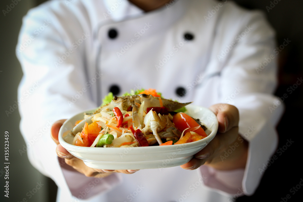 Wall mural chef proudly presenting thai spicy crab papaya salad - lao, isan cuisine