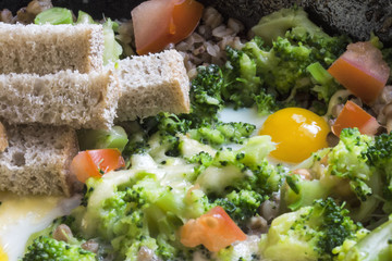 cook a delicious breakfast of scrambled eggs and broccoli close