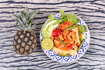 Spicy and sour vegetable salad with pineapple .