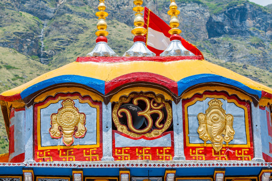 An Om symbol, discus and conch at the Badrinath Temple