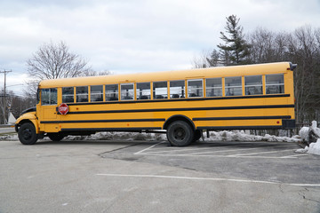 Plakat school bus parked outdoor in winter
