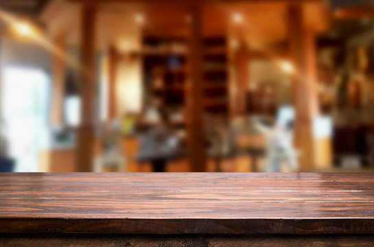 Selected focus empty brown wooden table and Coffee shop or resta