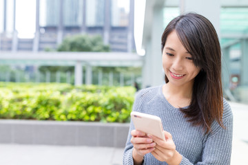 Woman using cellphone in Hong Kong