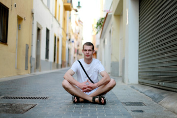 Fototapeta na wymiar Man sitting at one of the streets of Barcelona