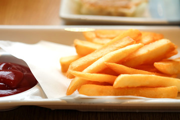 Close up French fries in a white dish on the table