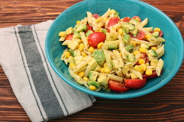 Cold pasta salad with avocado, tomato and olive oil