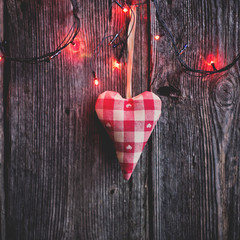 Heart on a wooden background with lights. The motive for Valenti