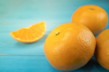 Oranges, close up whole orange fruits and sliced orange on wood