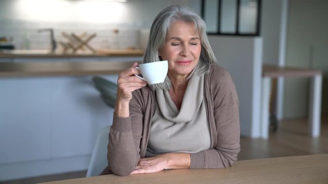 Senior woman at home drinking tea