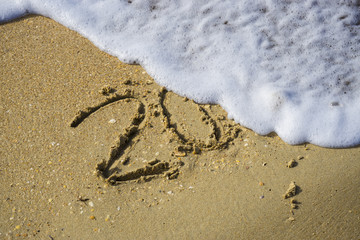 Abstract 2018 on a beach sand background