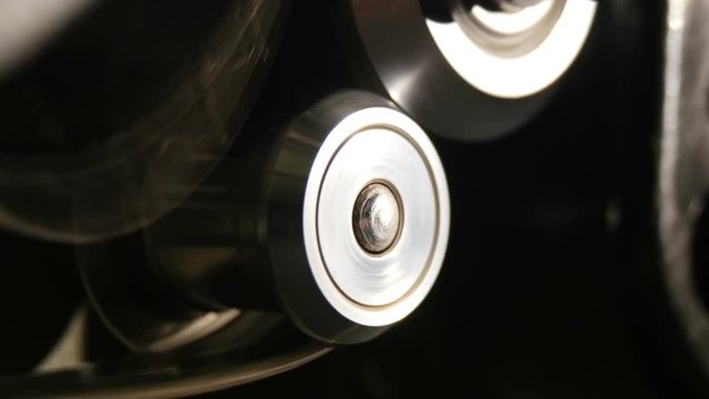 Two retro movie projector ball bearings spinning guickly.