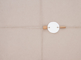 Cardboard decorated tag dough with wooden beads. Parcel a gift tied with jute paper.