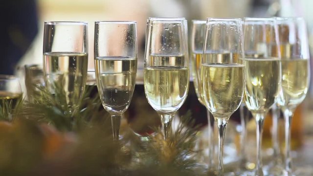 Glasses of champagne, close-up. Camera movement. Blurred background. 
