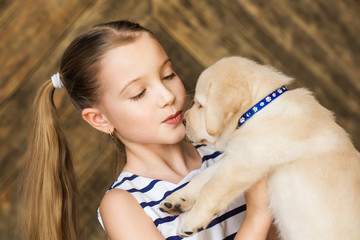 Little girl with a labrador puppy