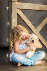 Little girl with a labrador puppy