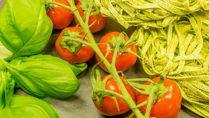 Pasta with fresh red tomatoes and basil. Italian food ingredients